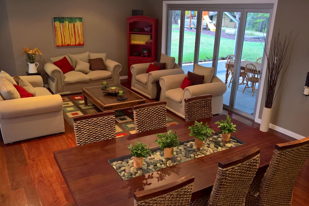 Main lounge and dining space with floor to ceiling bush views and overlooking the lap pool.