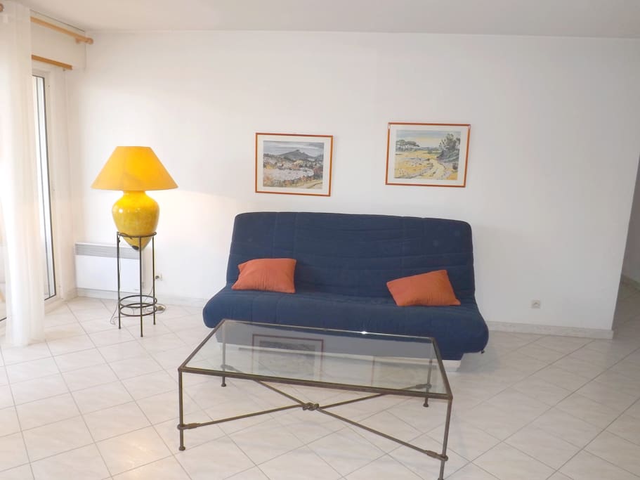 Convertible sofa by the sliding door to the terrace