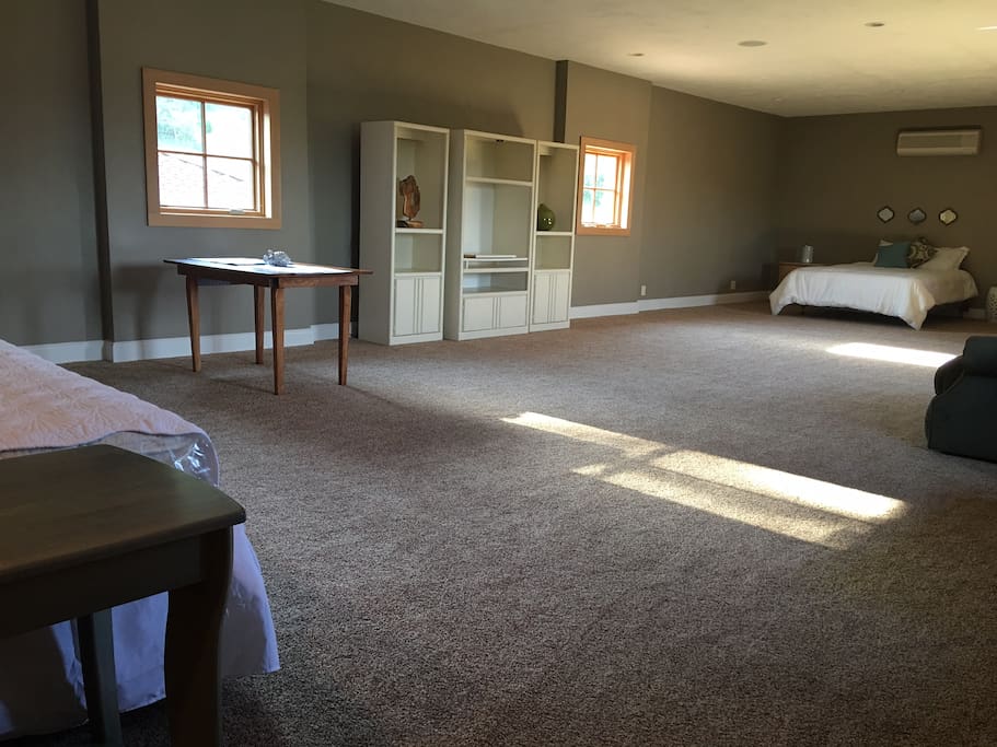 View from private entrance, at top of stairs, queen bed at right, 1 of 2 single daybeds at left.