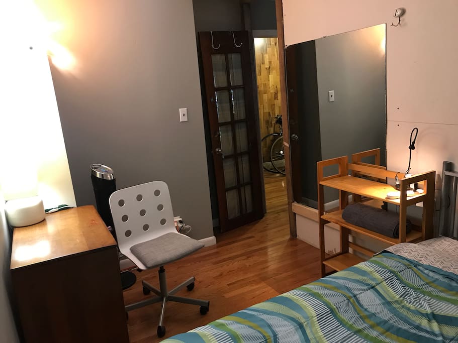 Your bedroom also includes a small desk/cabinet, rolling chair, powerful cooling fan, tall shelving for clothes and personal items, as well as a locking door with key.
