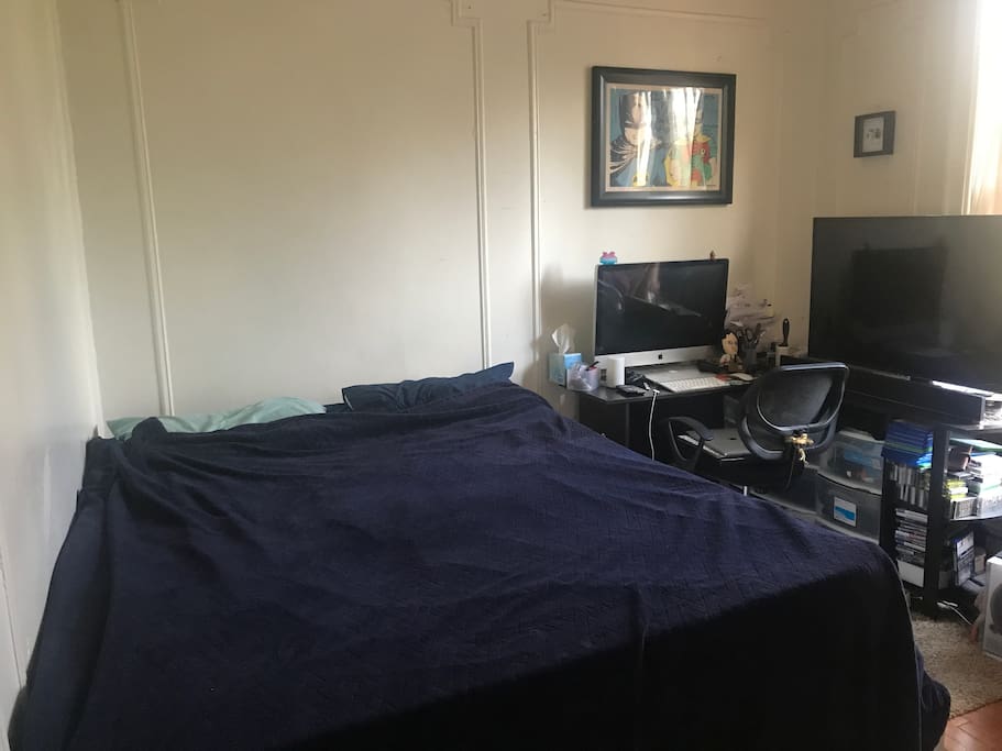 Bedroom. Queen sized bed and L-shaped desk with storage drawers under the desk. (TV and iMac will not be in the room)