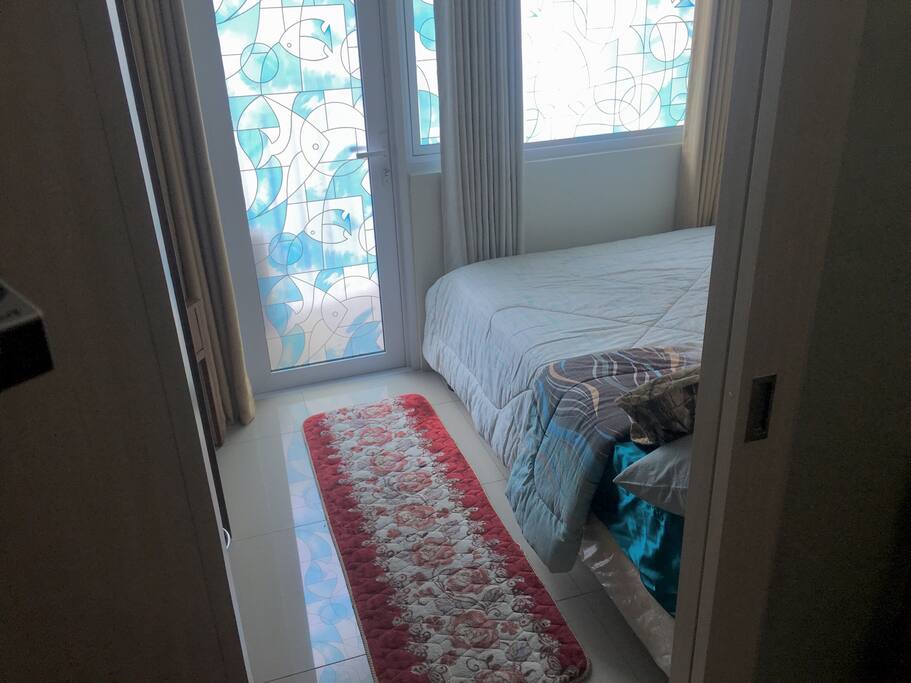 Bedroom is enclosed with a sliding door to the balcony