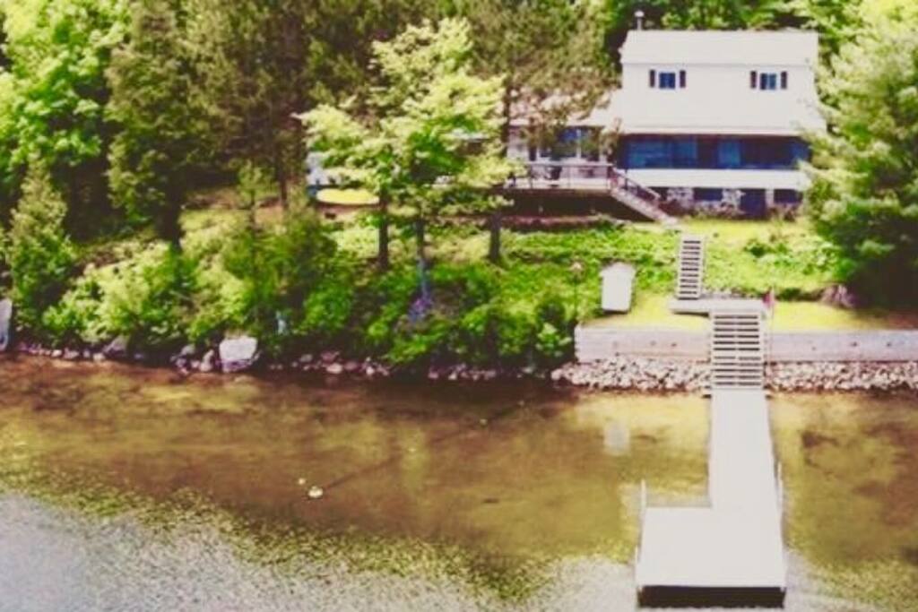 Shallow sandy entry with deep diving off the dock and no weeds so no worries