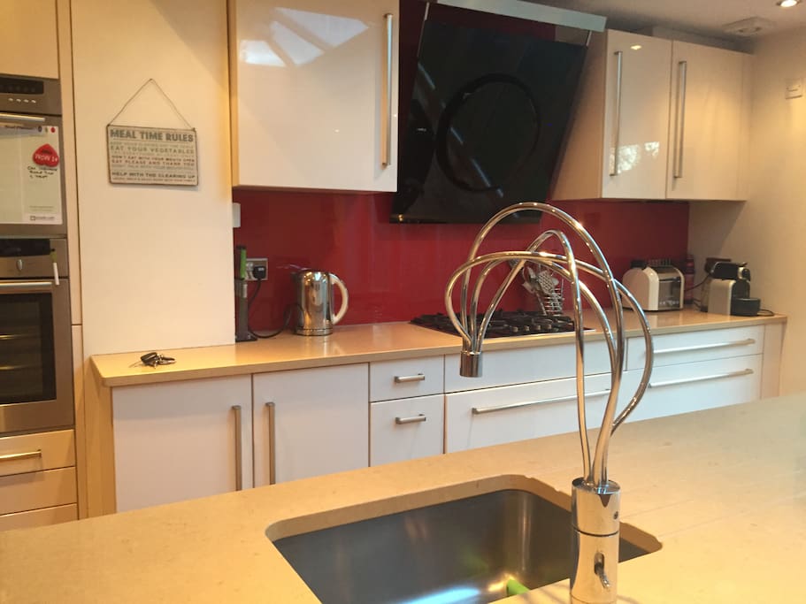 Stare of the art kitchen with designer taps and extractor