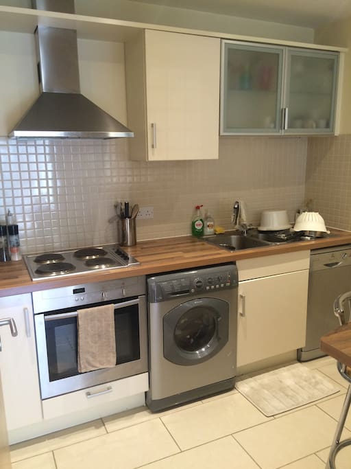 Modern kitchen with all amenities including slow cooker, nutri bullet and bread maker.