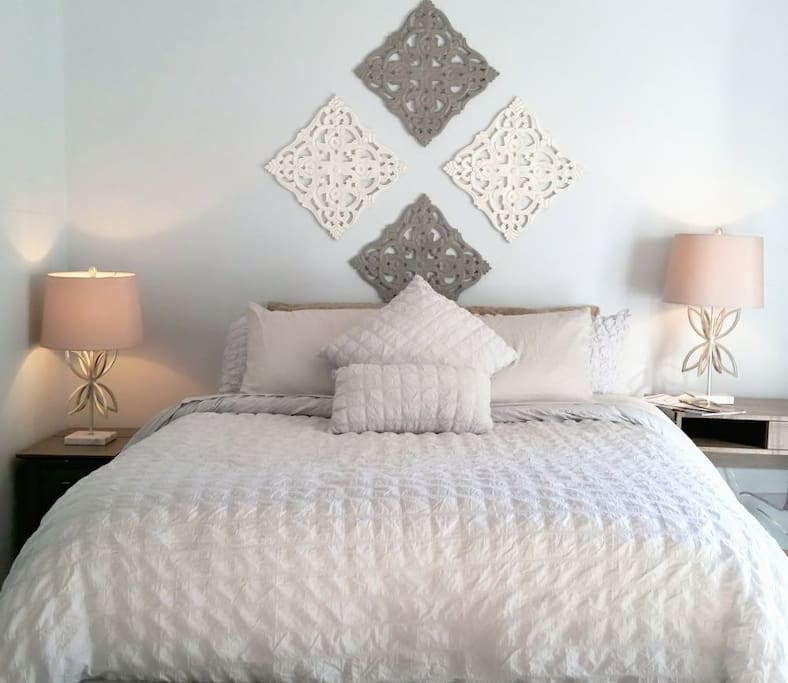 Comfy Queen size bed is the centerpiece of this professionally designed and intentional space