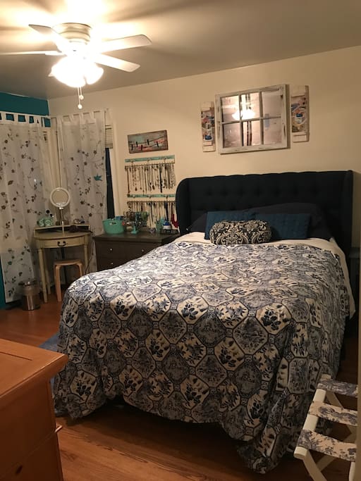 Queen bed with memory foam topper, dressing table, space in armoire, view out window