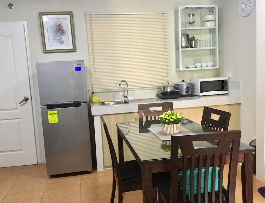 The woody 4 seater dining with the kitchen furnished with basic kitchen utensils for your light cooking :)