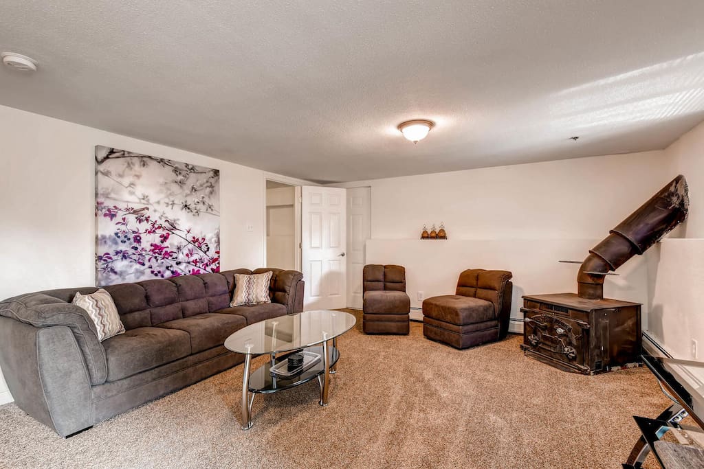 Primary living room, Brand new, never-used furniture throughout. Wood stove is decorative only - not operable.