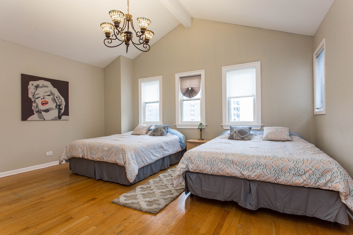 Each bedroom has its own style. This bedroom has two queen beds, beautiful fun art and lots of room to move around. Bedroom has en-suite bath