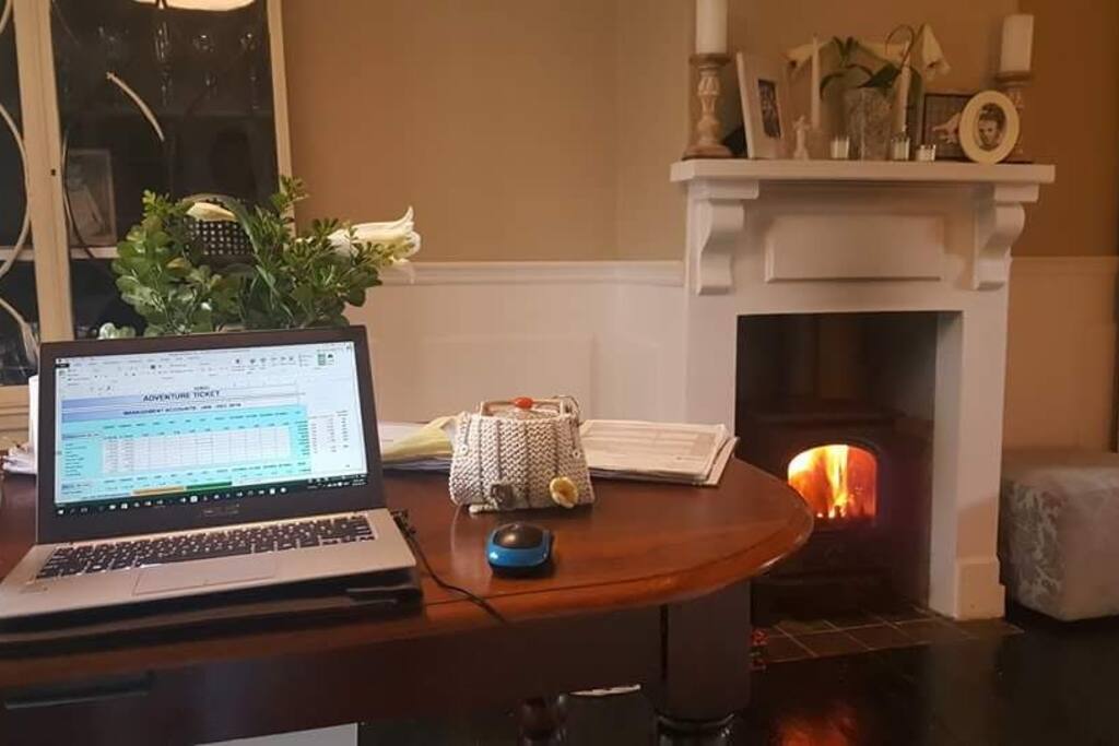 The dining room table adjacent to the fireplace
