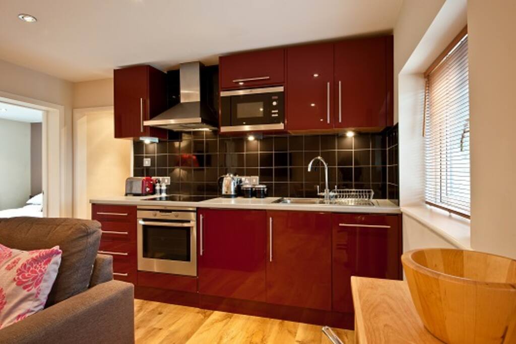 Modern kitchen, cooker, hob, microwave, fridge/freezer, dishwasher and washing machine.