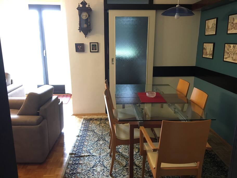 View from the entrance door to the dining and living room. The light is coming from the balcony door.