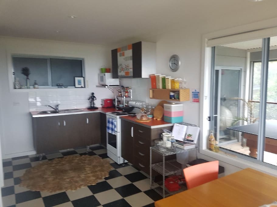 Stove, microwave, toaster, kettle, all you might need in a compact kitchen.