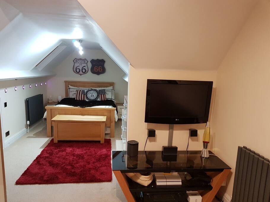 Bedroom with large TV and Sofa