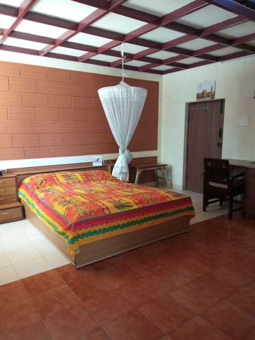 Queen bed, mosquito net and desk