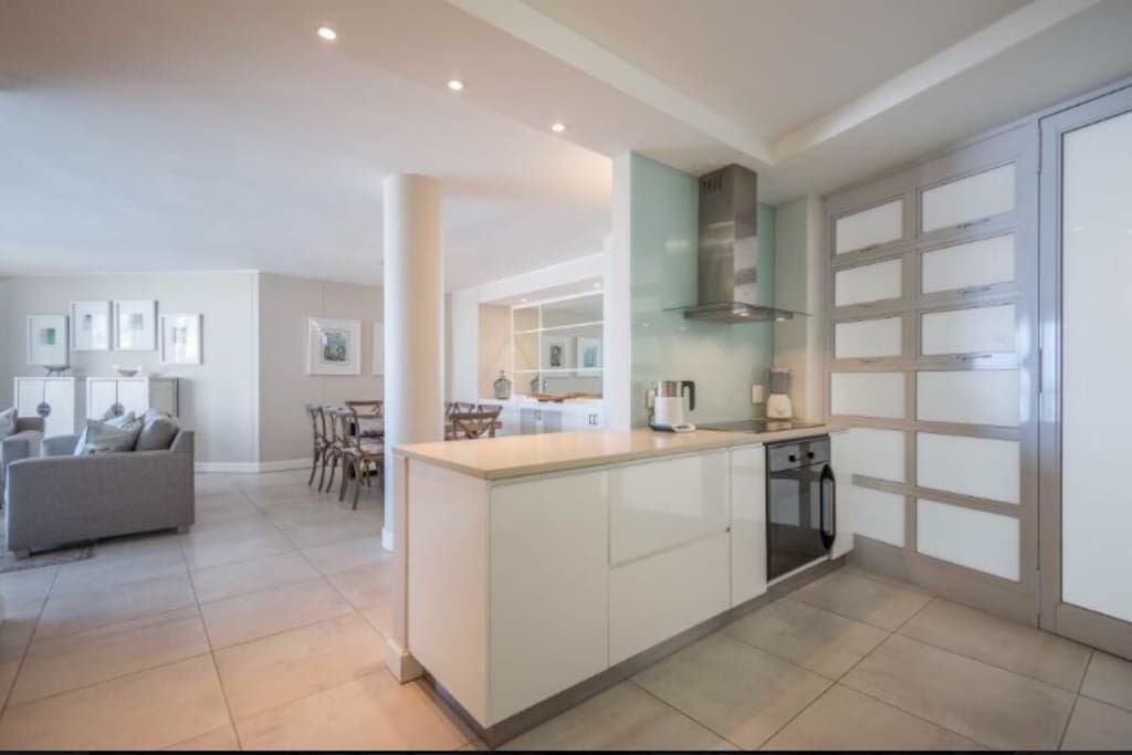 Open plan fresh and clean looking kitchen and dining room