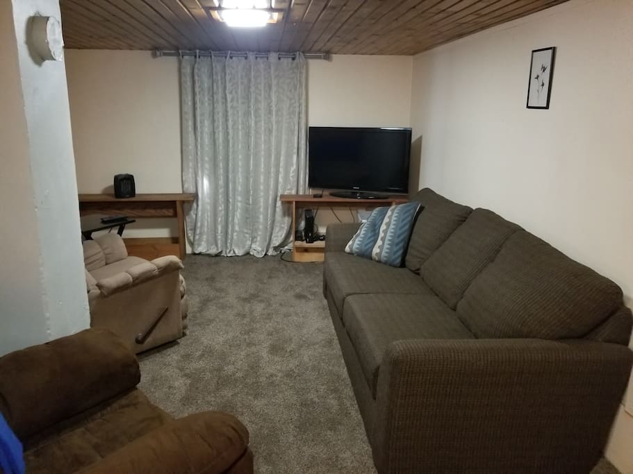 Your privet comfy living room for you, couch, overstuffed chairs, recliner, flatscreen tv, table and chairs
