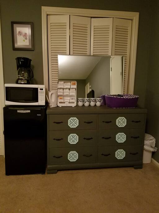 Kitchenette includes mini fridge, microwave, coffee maker, electric kettle, plus coffee, tea, and granola bars.