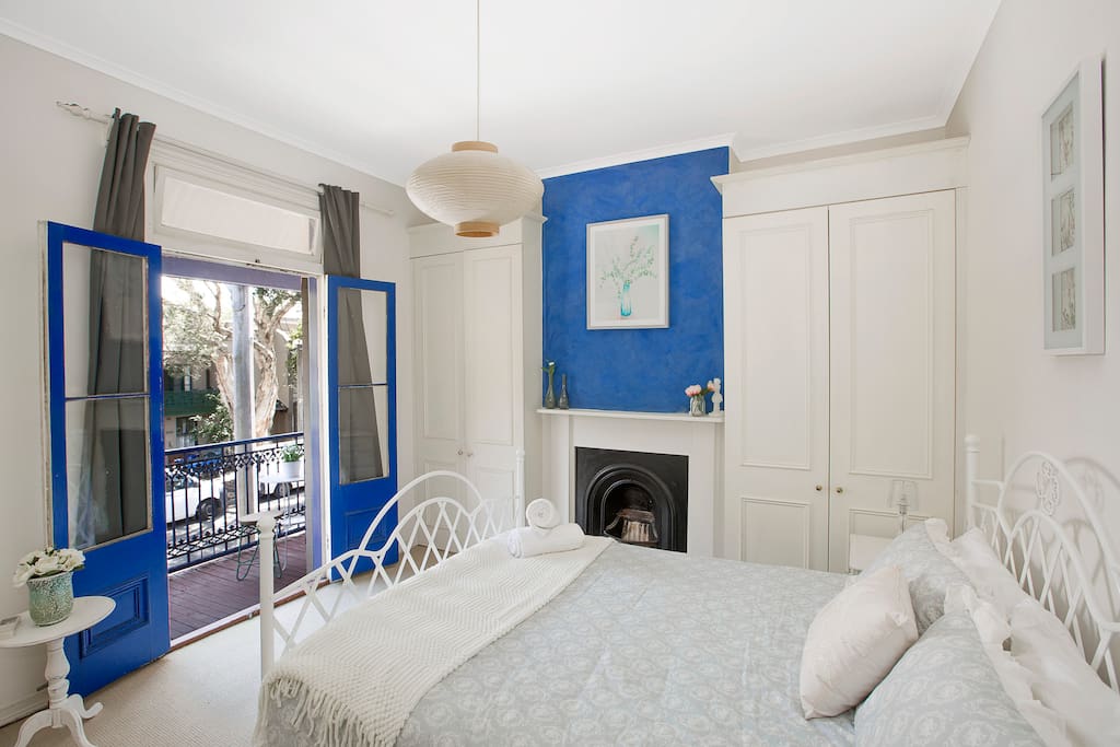 Large, Bright and Comfortable Main bedroom with feature wall, fireplace, A/C and private balcony