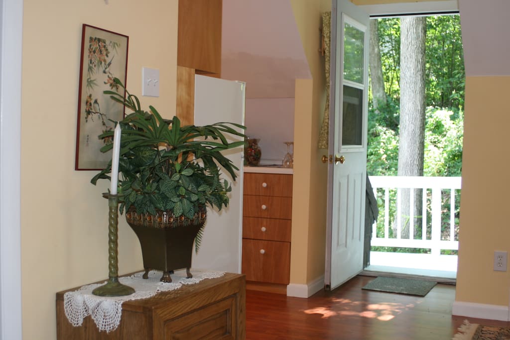 Peek of kitchen on the left and view of the main entrance door with Main Deck.