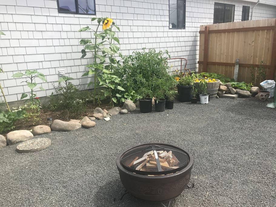 Garden view and private outdoor area with fire pit.