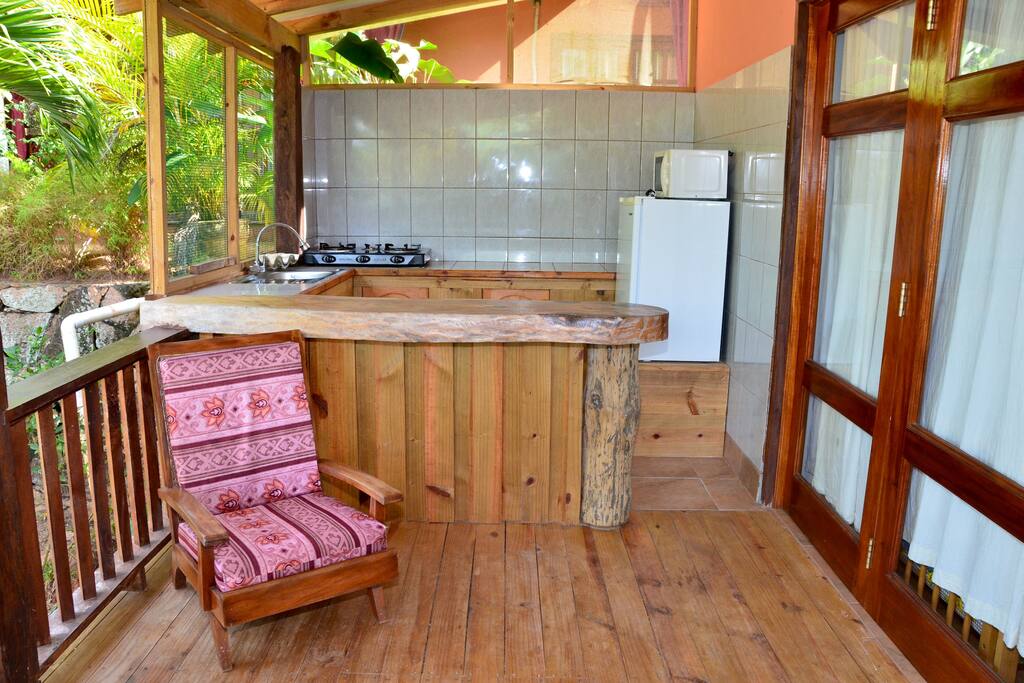 Kitchen with stove, fridge, microwave, cutlery, etc