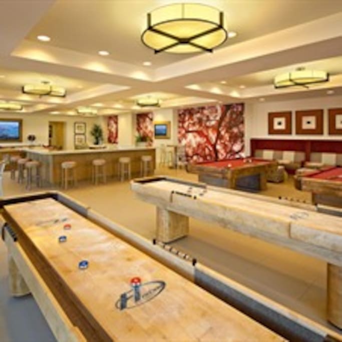 Game room with poker table, 2 shuffle board and 2 pool tables, large screen tv, etc