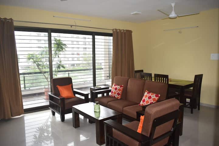 Spacious Living & Dining area with solid wood furniture.