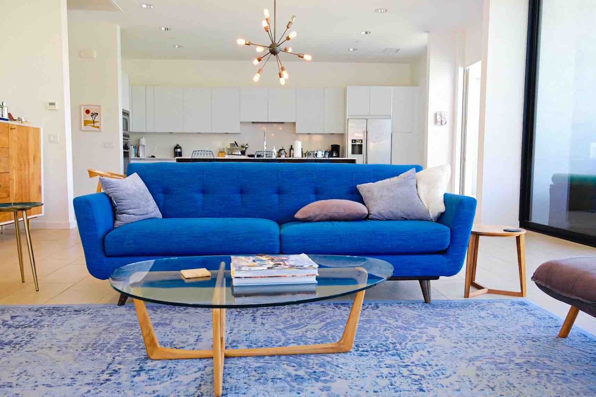 Living room with blue sofa and sputnik chandelier