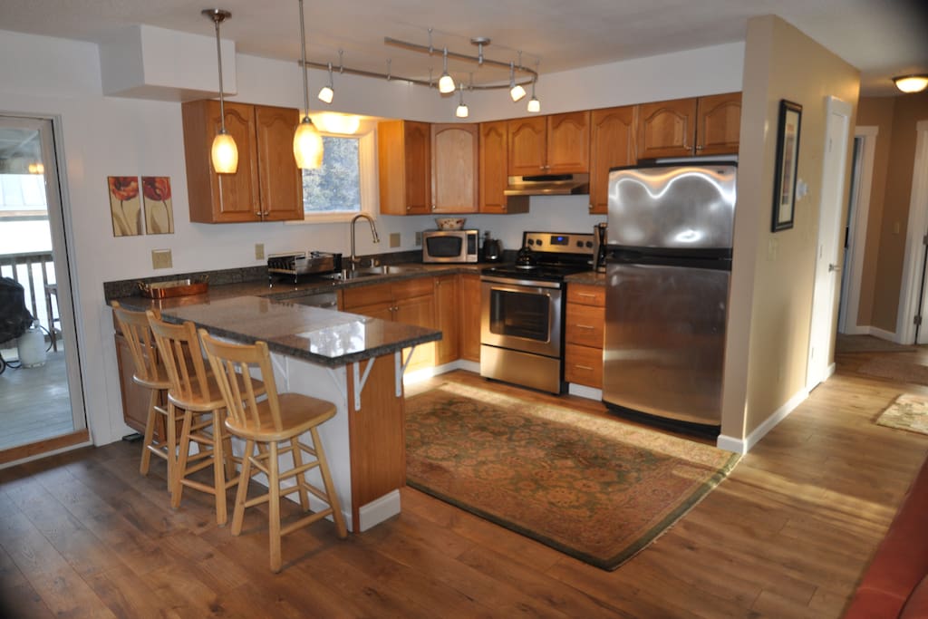 Open kitchen, stainless appliances, bar seating