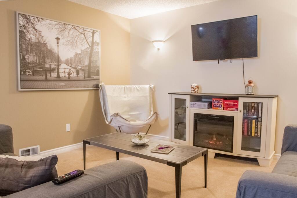 The electronic fireplace, book collection, and board games make for a cozy stay.