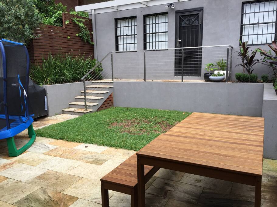Courtyard with BBQ and trampoline.