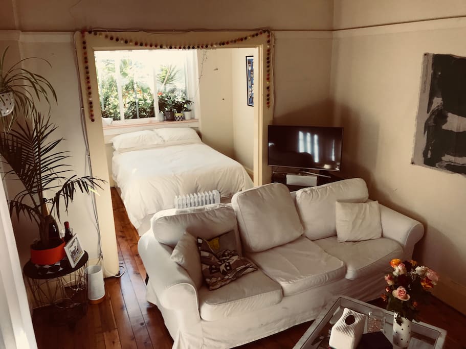 Lounge area, with 3 seat couch and TV