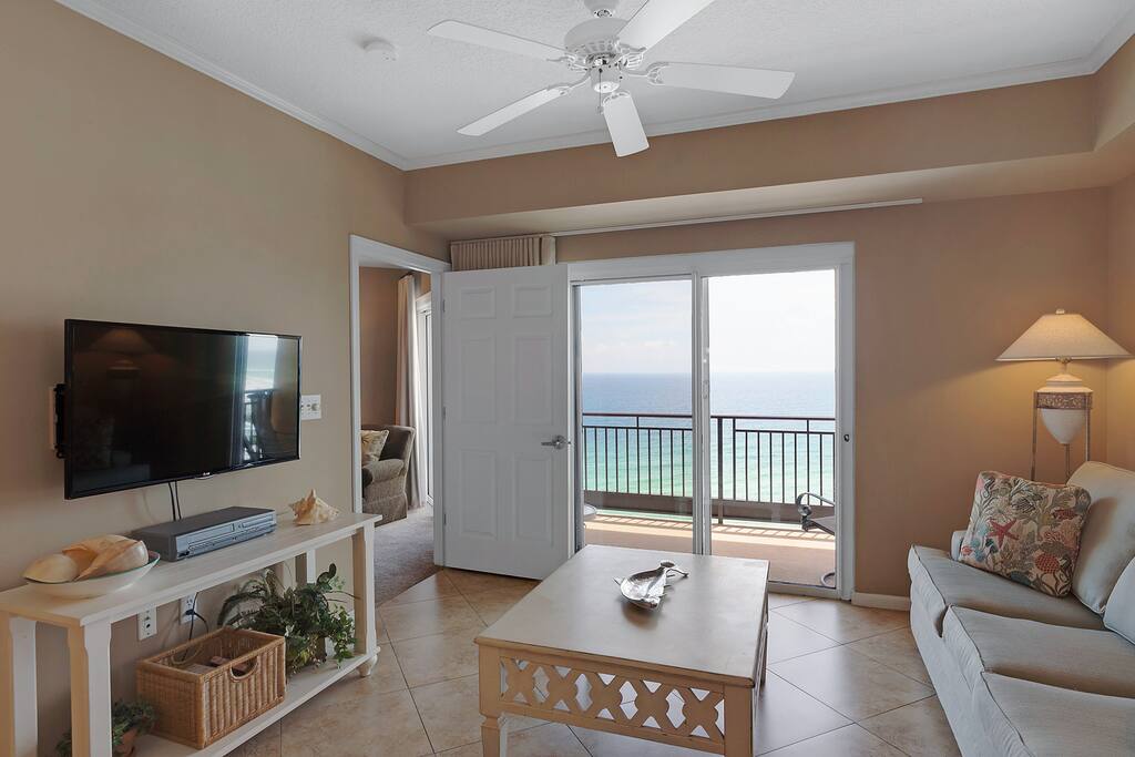 Large flat panel TV in living area with balcony access