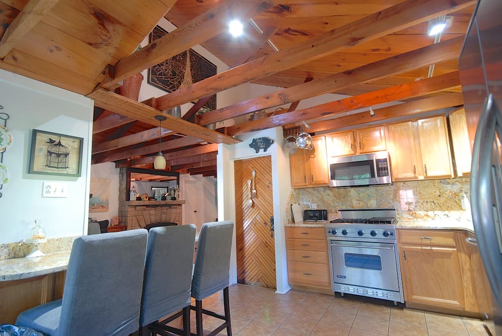 Viking stove and cabinets stocked with dishes and cookware