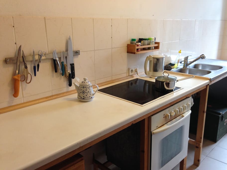 knives, oven, stovetop, deep double sink, and there is a dishwasher just out of sight!
