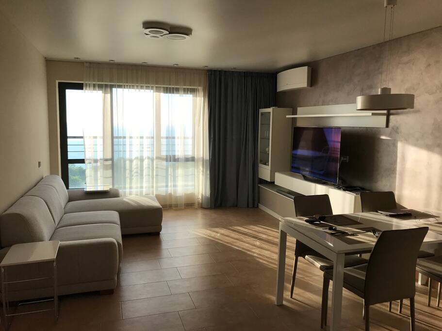 The living room with a TV and a balcony with an 180 degree view of the black sea.