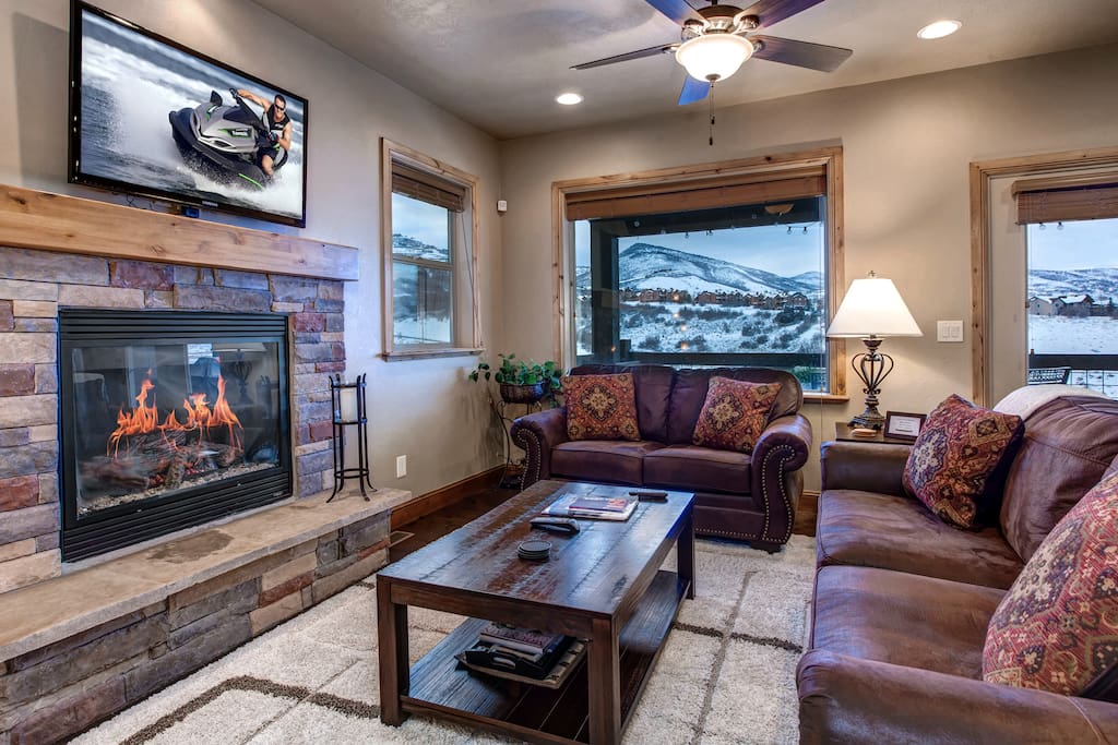 Main Level Great Room - Large HD TV, seating, gas fireplace, ceiling fan, balcony access