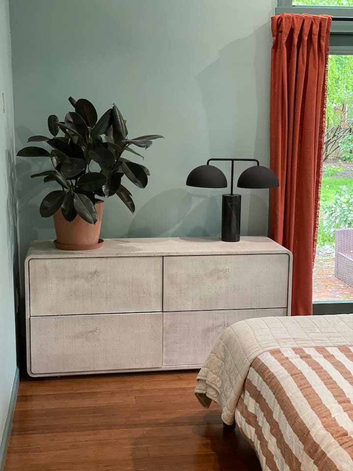 Primary Bedroom #1, with queen bed, window nook, adjoining bathroom. Sliding doors lead directly out to patio.