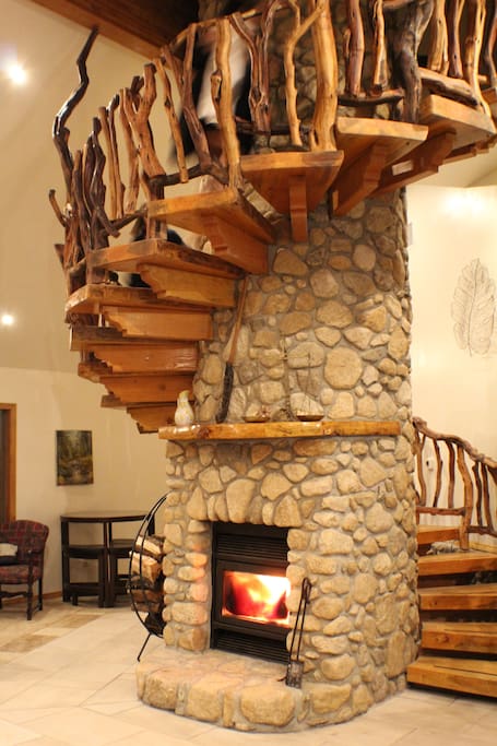 The iconic Manzanita spiral staircase and stone chimney is the centerpiece of the living room!