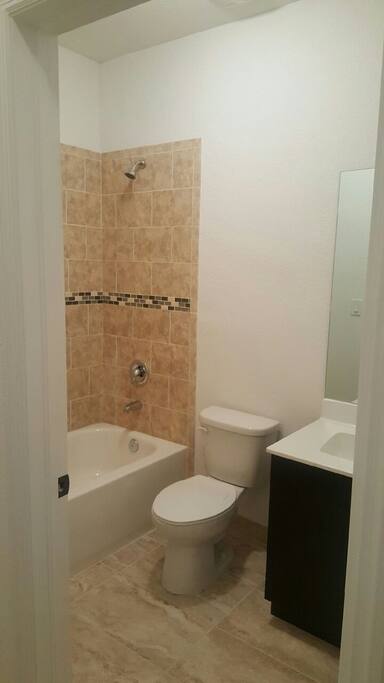 Clean, beautiful tile bathtub.