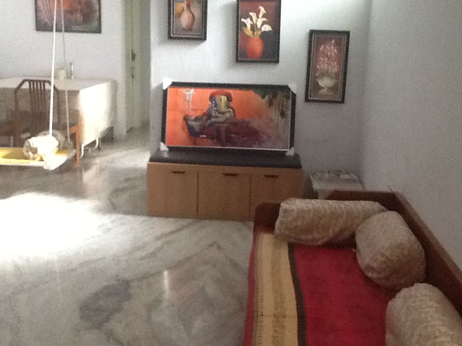 Living room with swing and attached with dining room.