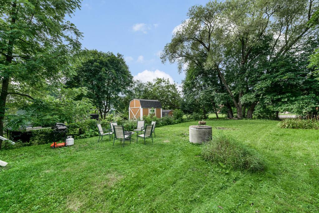 Back yard with seating area, firepit and bbq.