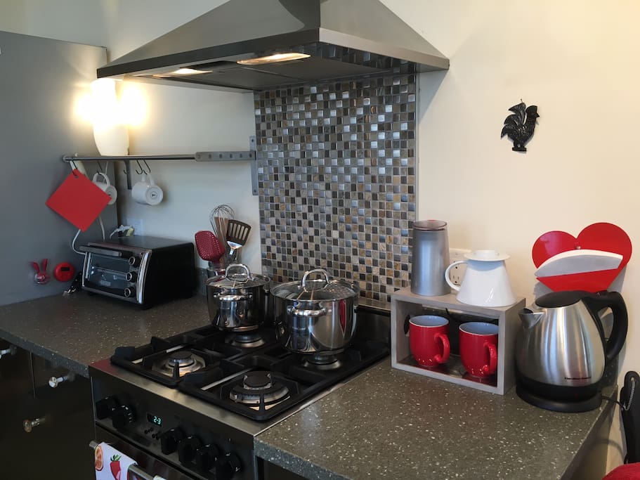 Kitchen with utensils & coffee supplies.