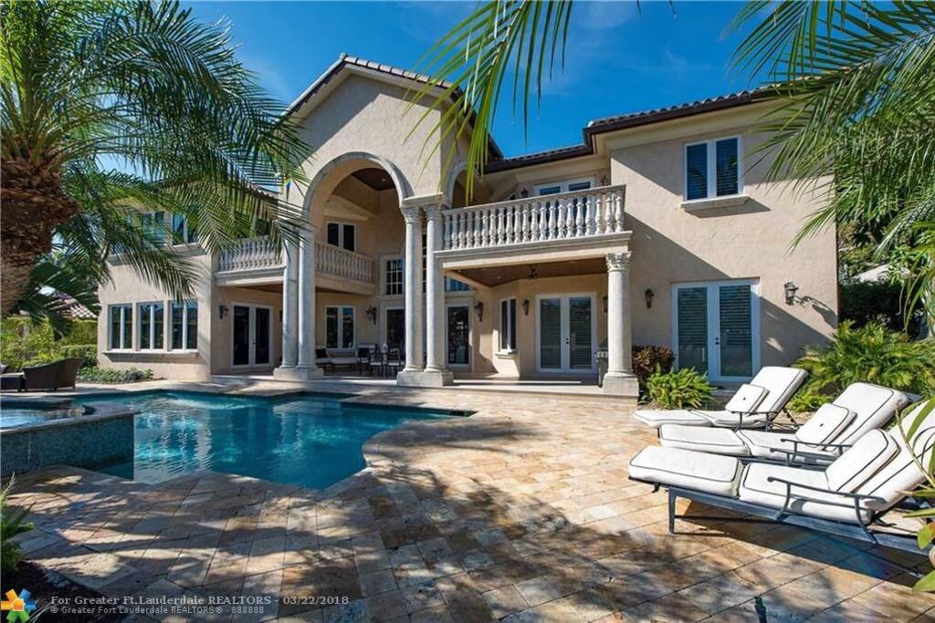 Back of the house with pool, jacuzzi, grill, outside lounging and dining