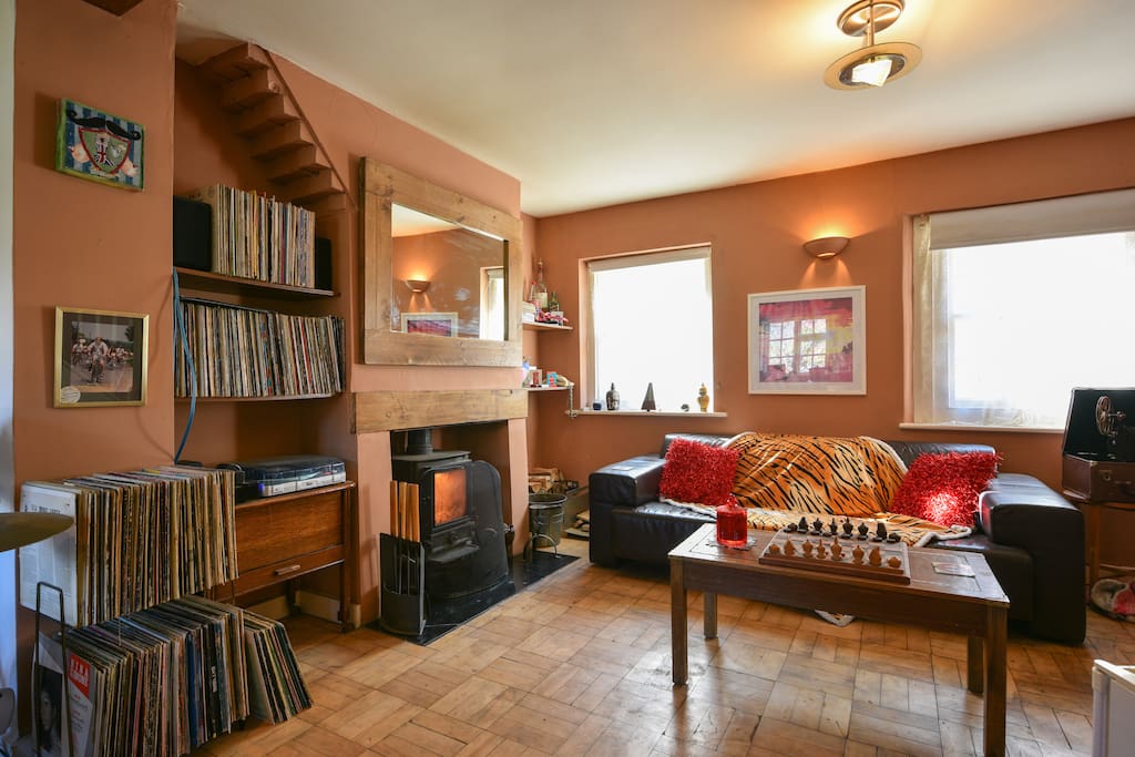 The living room with wood burning fireplace and access to over 400 vinyl l.P's and movies available to view on request from my attic archive stash.