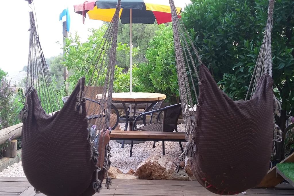 Welcome to Shanti heaven. The backyard swings invite you to sit and relax. hammock swings on the wrap around porch kissing the mountain-side.