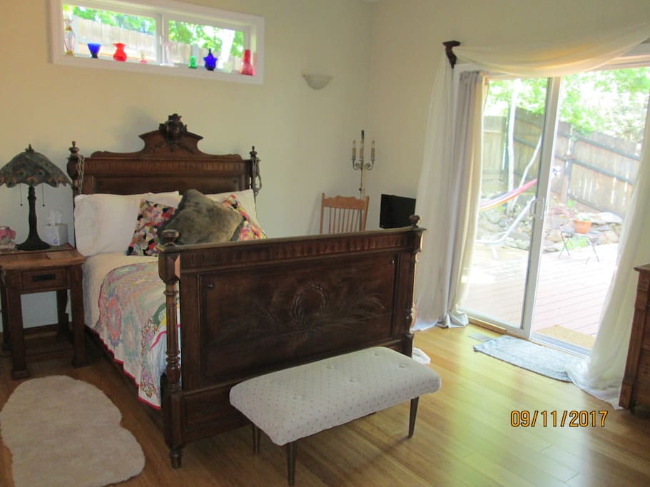 Master bedroom with slider leading to backyard, pond and beautiful large deck for dining and relaxing