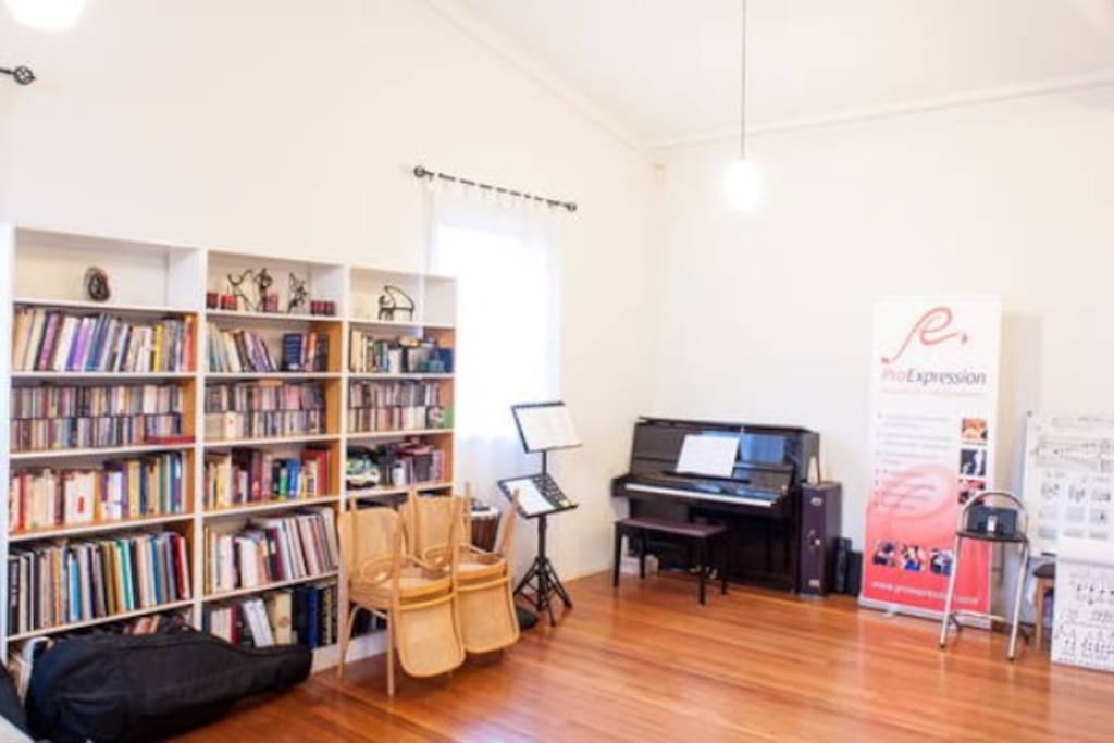 The main room - a welcome, bright, spacious music teaching and lounge room. The couch is so comfy to relax on, read a book or act as two extra sleeping spaces..